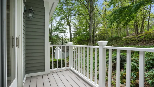 an empty room with windows and fireplace