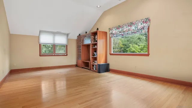 a view of an empty room with a window and storage