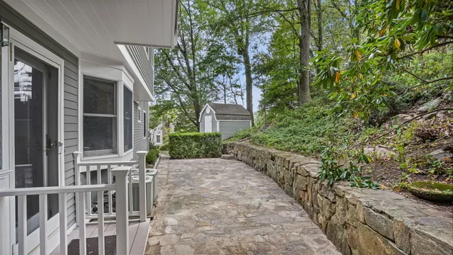 a back view of a house with a yard and sitting area