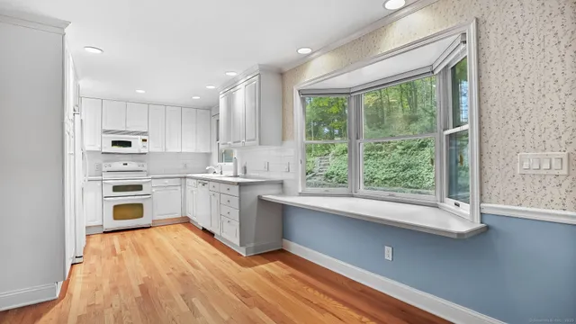 a kitchen with cabinets appliances and a sink