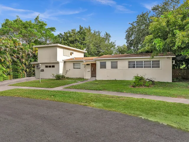 a view of a house with a yard and a garden