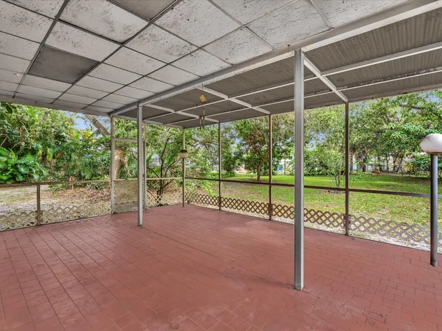 a view of a backyard with barn and large trees