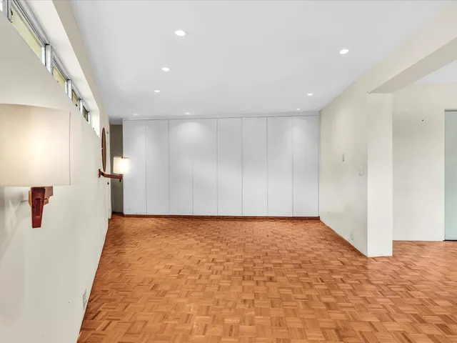 a view of a hallway with a wooden fence