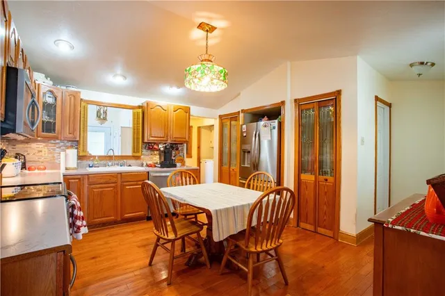 a large kitchen with a table and chairs
