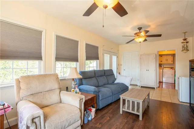 a living room with furniture ceiling fan and a window