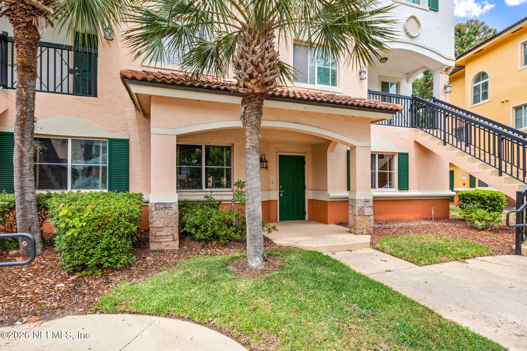 a front view of a house with a garden