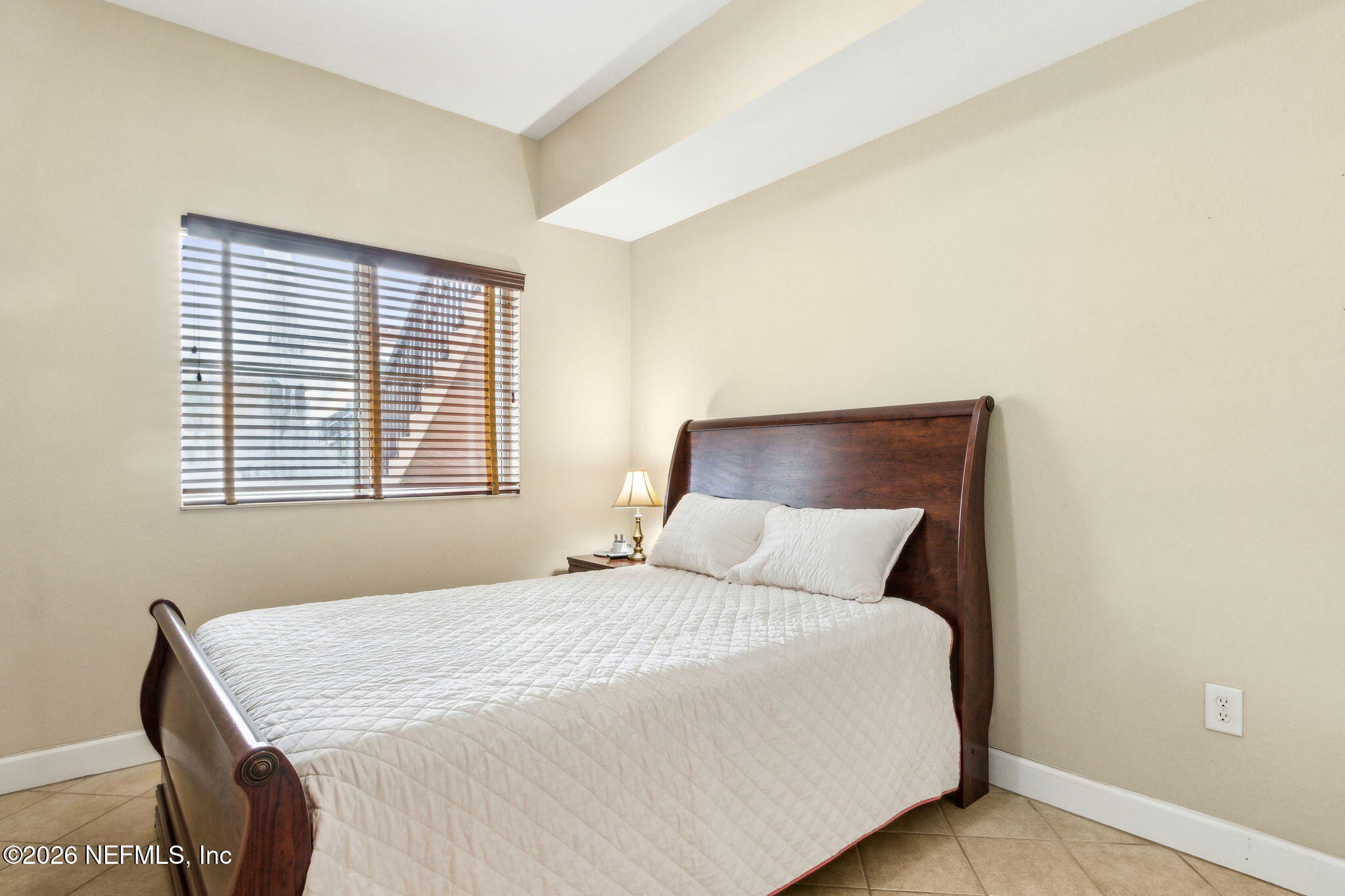 9745 Touchton Road, Unit 1205 Jacksonville, FL 32246 - Photo 12 of 20 a bedroom with a bed and a window