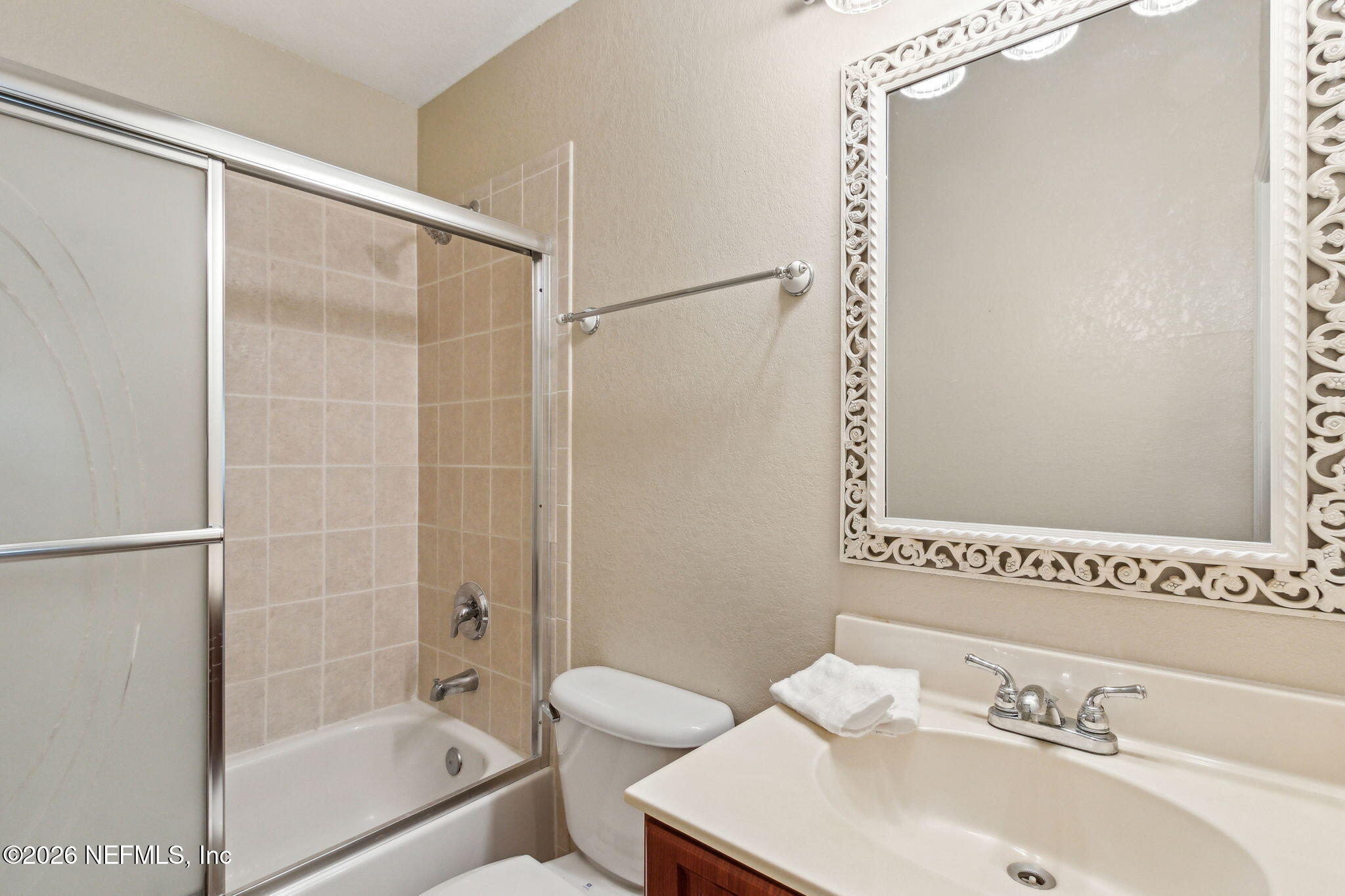9745 Touchton Road, Unit 1205 Jacksonville, FL 32246 - Photo 14 of 20 a bathroom with a sink and a mirror