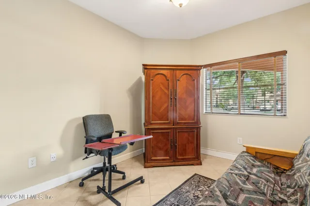 a bedroom with furniture and a window