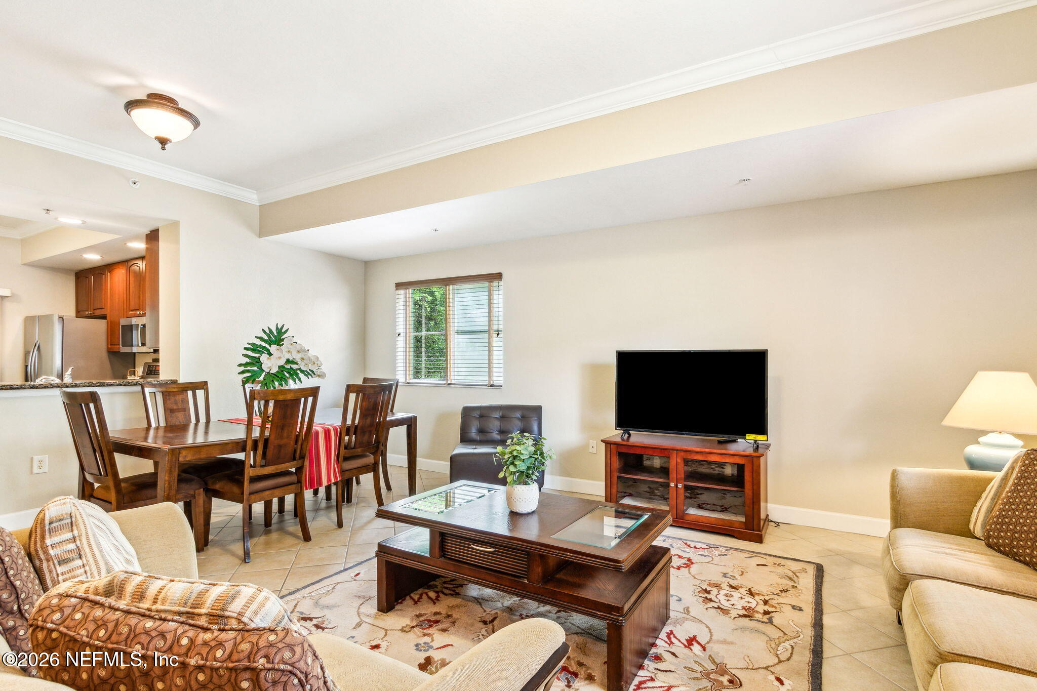 9745 Touchton Road, Unit 1205 Jacksonville, FL 32246 - Photo 2 of 20 a living room with furniture and a flat screen tv