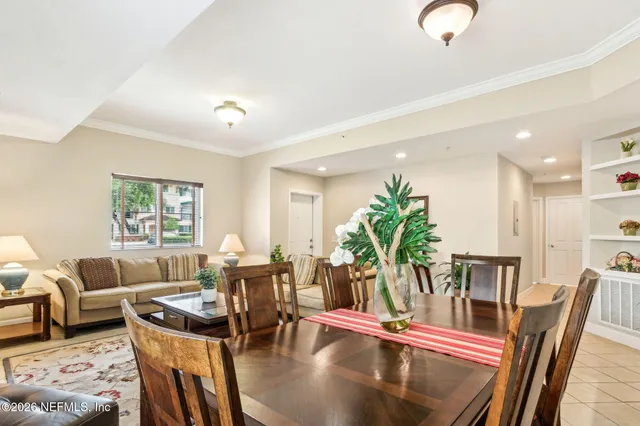 a living room with furniture flowerpot and wooden floor