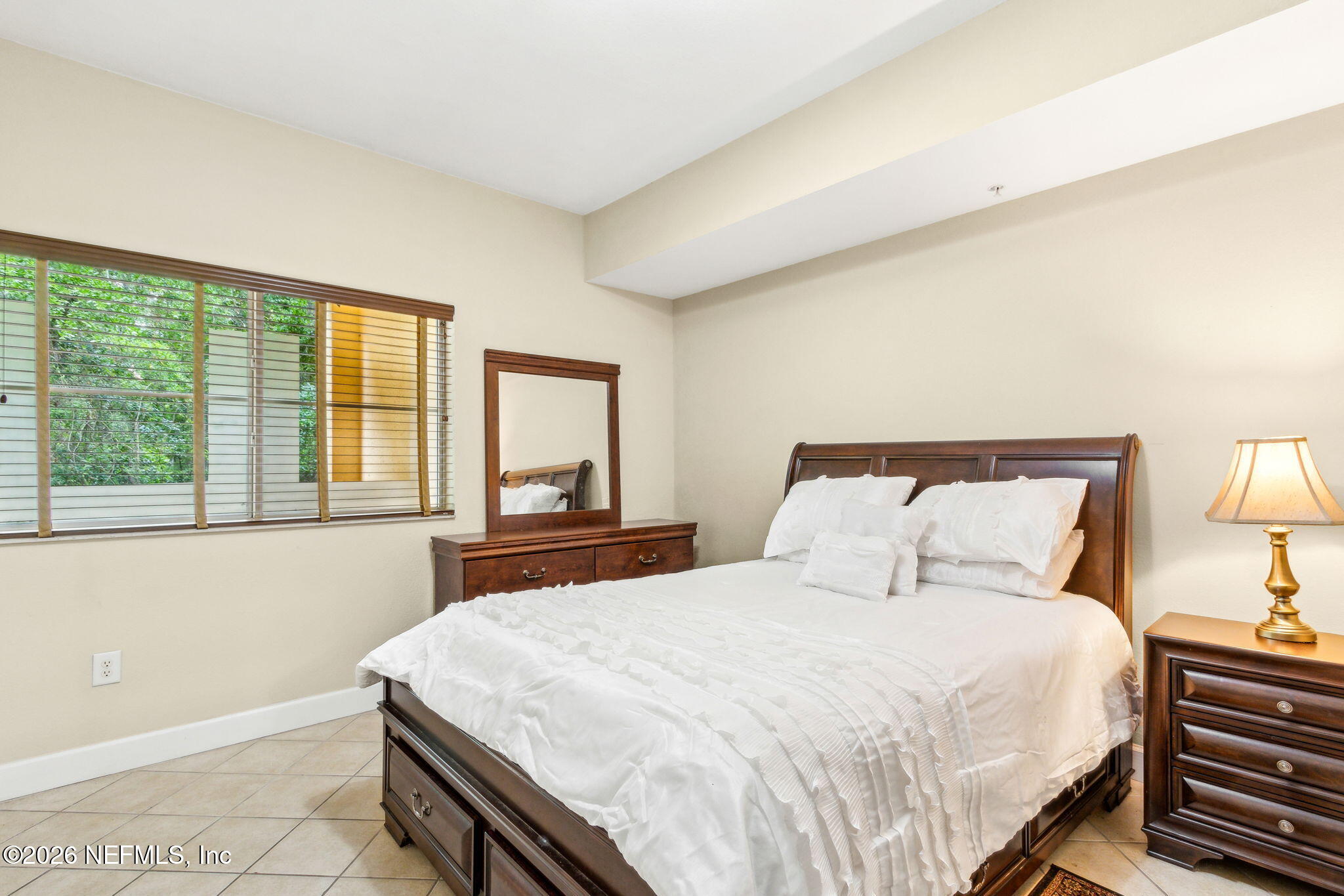 9745 Touchton Road, Unit 1205 Jacksonville, FL 32246 - Photo 8 of 20 a bedroom with a bed and a large window