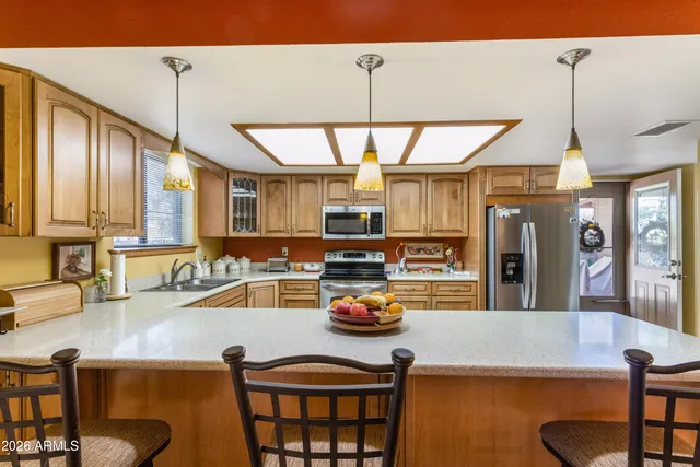 a kitchen with a table chairs and a chandelier