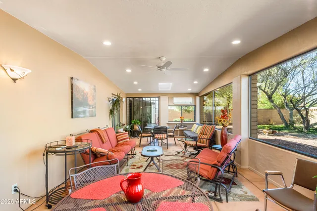 a living room with furniture and large windows