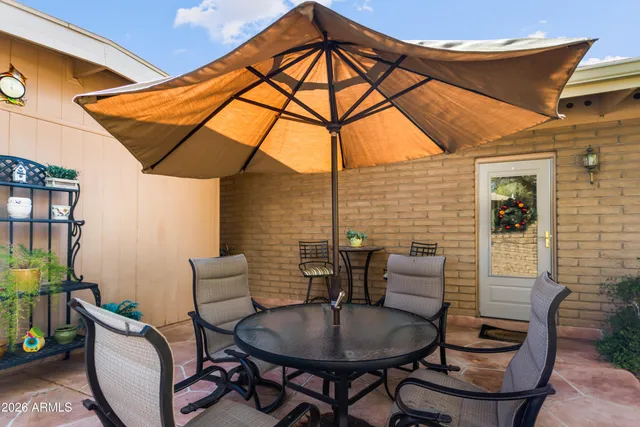 a backyard of a house with table and chairs