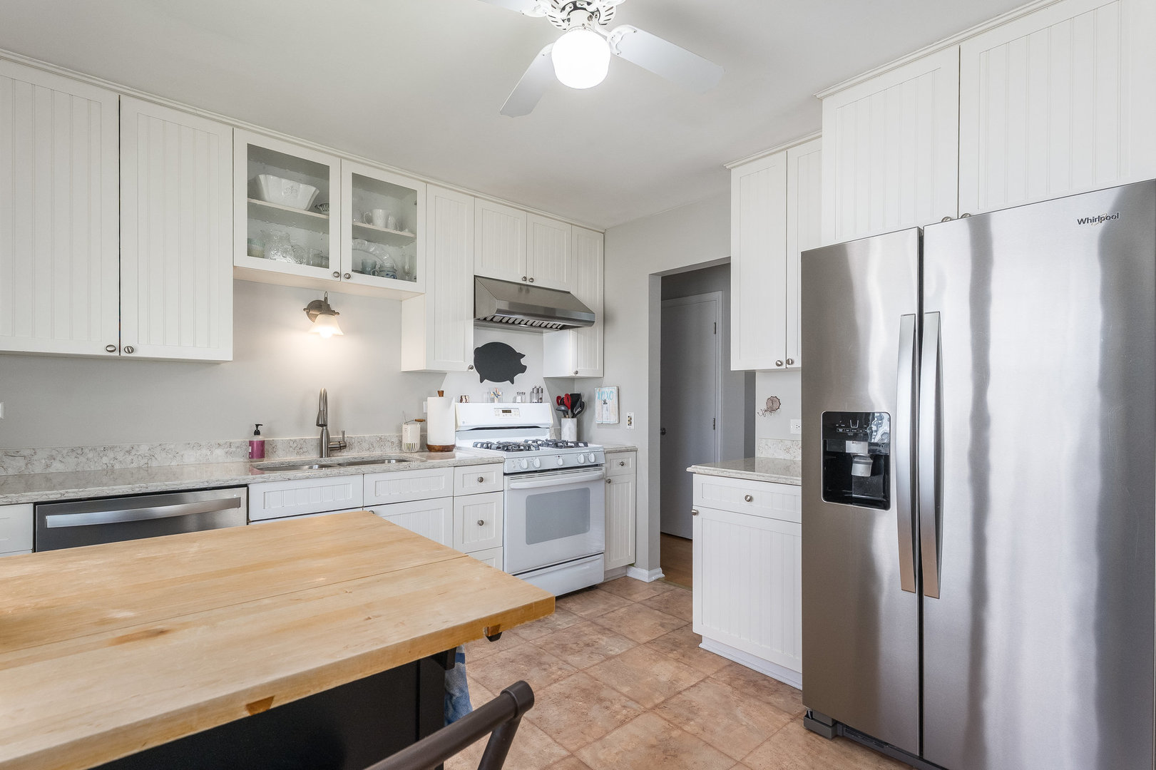 1617 Orth Drive Wheaton, IL 60189 - Photo 9 of 35 a kitchen with stainless steel appliances a refrigerator sink and stove