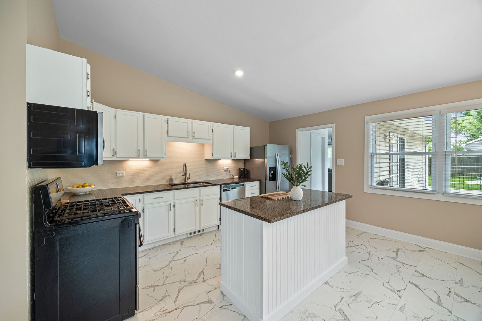 2117 Grouse Lane Rolling Meadows, IL 60008 - Photo 4 of 25 a kitchen with granite countertop a sink stove and cabinets