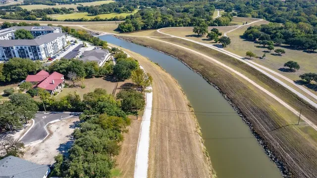 an aerial view of a house with a yard and lake view