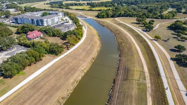 a view of a swimming pool with a lot of flower plants