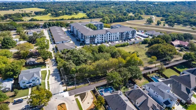 an aerial view of a house with a garden and lake view