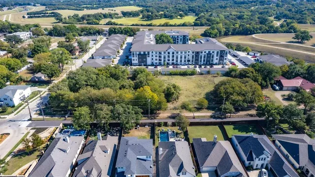 an aerial view of a house with garden space and street view