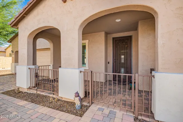 a view of a house with large windows and wooden fence