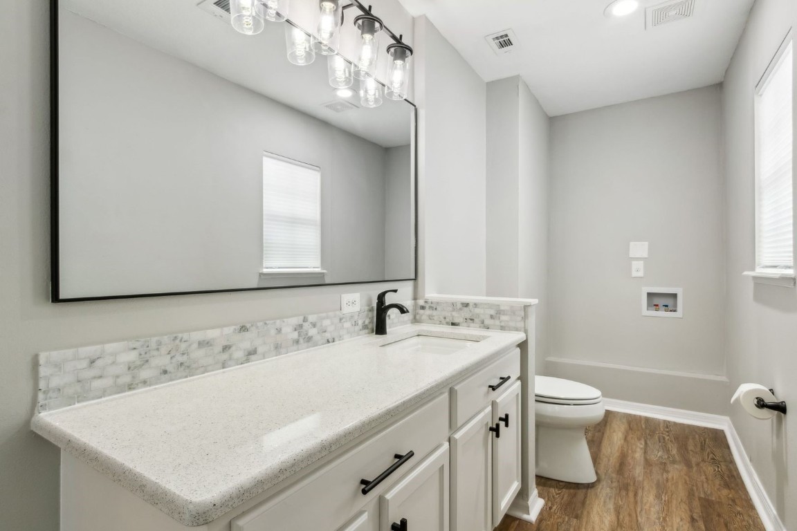 76367 Longleaf Loop Yulee, FL 32097 - Photo 20 of 49 a bathroom with a sink a toilet and a mirror