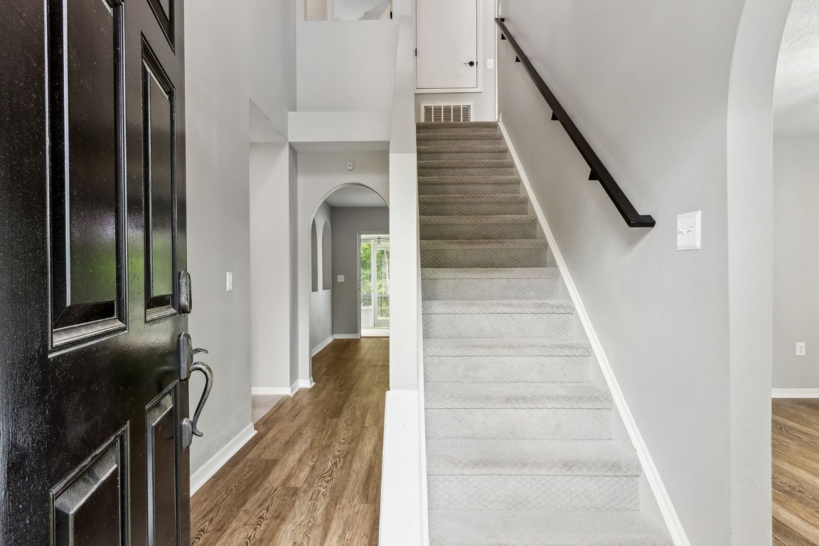 76367 Longleaf Loop Yulee, FL 32097 - Photo 2 of 49 a view of a hallway with wooden floor and staircase