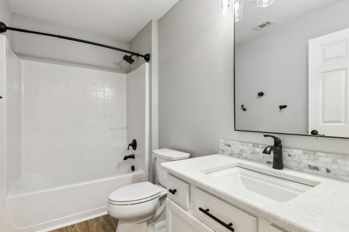 76367 Longleaf Loop Yulee, FL 32097 - Photo 24 of 49 a bathroom with a granite countertop sink toilet and shower