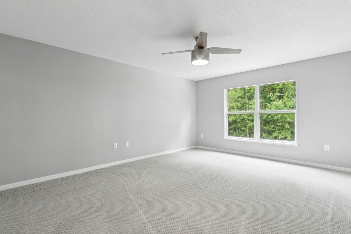 76367 Longleaf Loop Yulee, FL 32097 - Photo 30 of 49 an empty room with a window and a ceiling fan