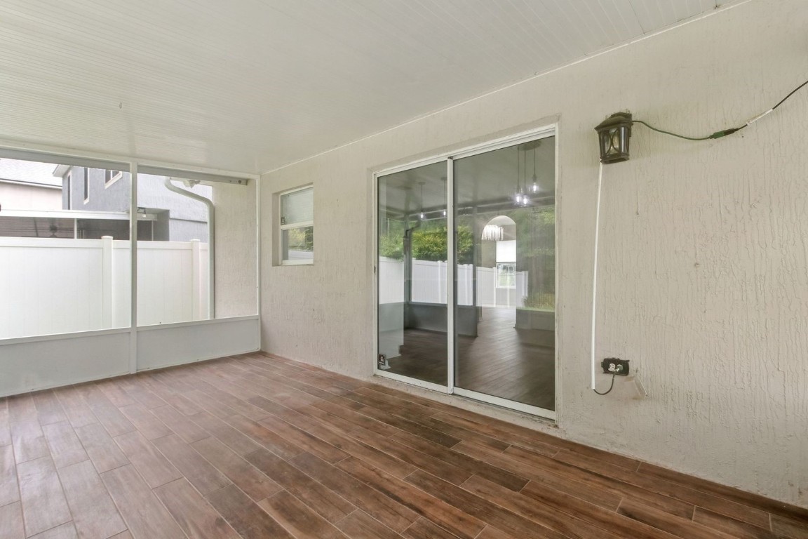 76367 Longleaf Loop Yulee, FL 32097 - Photo 33 of 49 an empty room with wooden floor and door