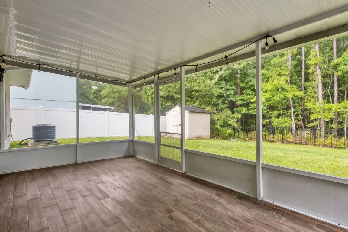 76367 Longleaf Loop Yulee, FL 32097 - Photo 34 of 49 en empty room with sliding door and wooden floor