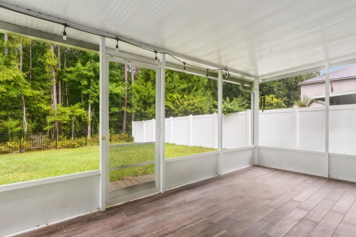 76367 Longleaf Loop Yulee, FL 32097 - Photo 35 of 49 a view of an empty room with a floor to ceiling window and a yard