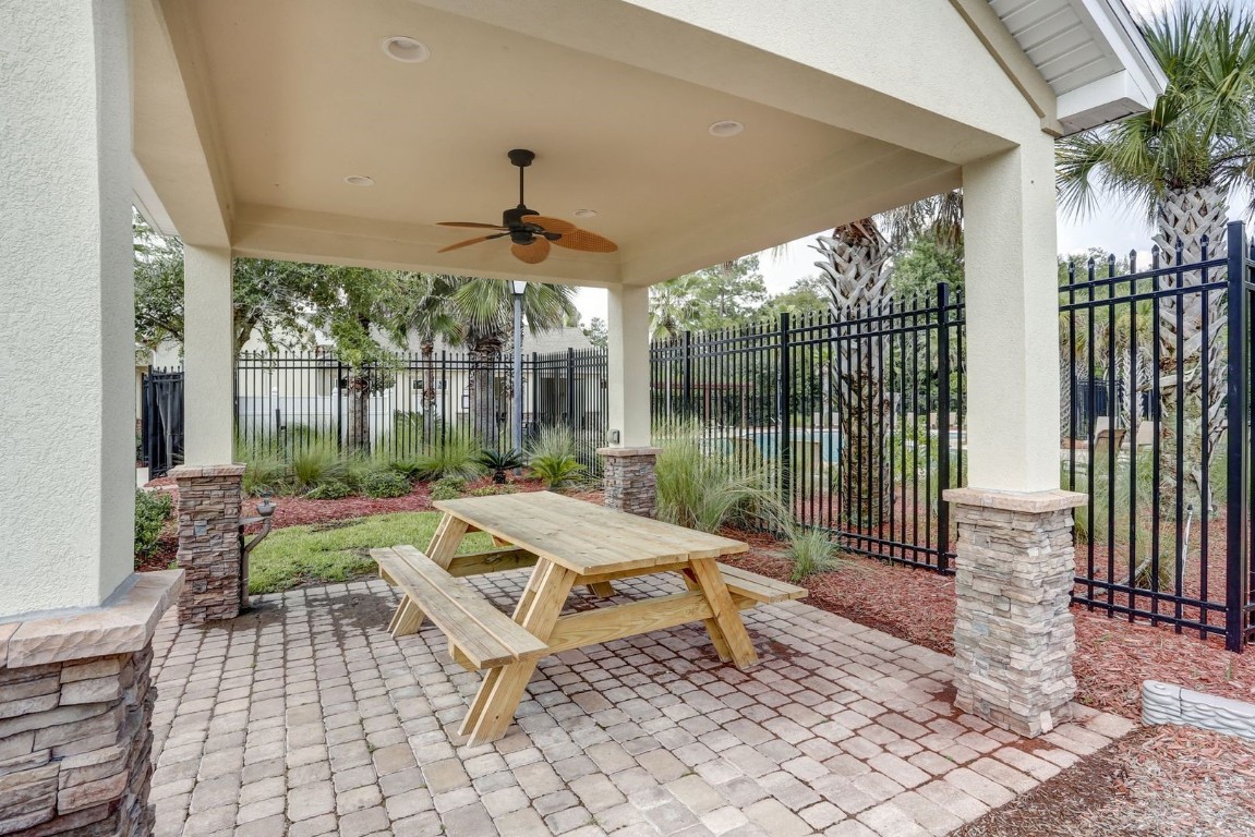 76367 Longleaf Loop Yulee, FL 32097 - Photo 49 of 49 a view of a patio with a dining table and chairs
