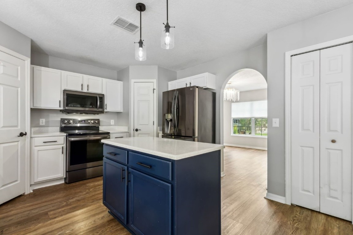 76367 Longleaf Loop Yulee, FL 32097 - Photo 6 of 49 a kitchen with a sink stove and refrigerator