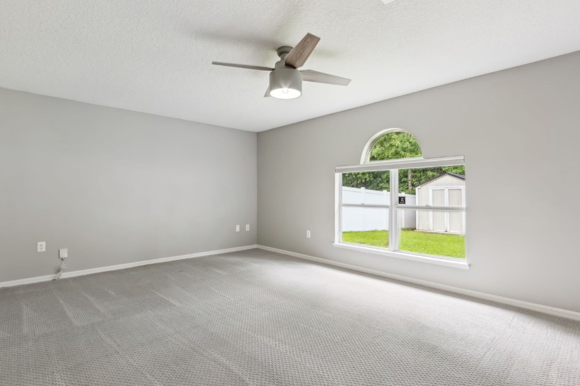 76367 Longleaf Loop Yulee, FL 32097 - Photo 10 of 49 an empty room with a window and a ceiling fan