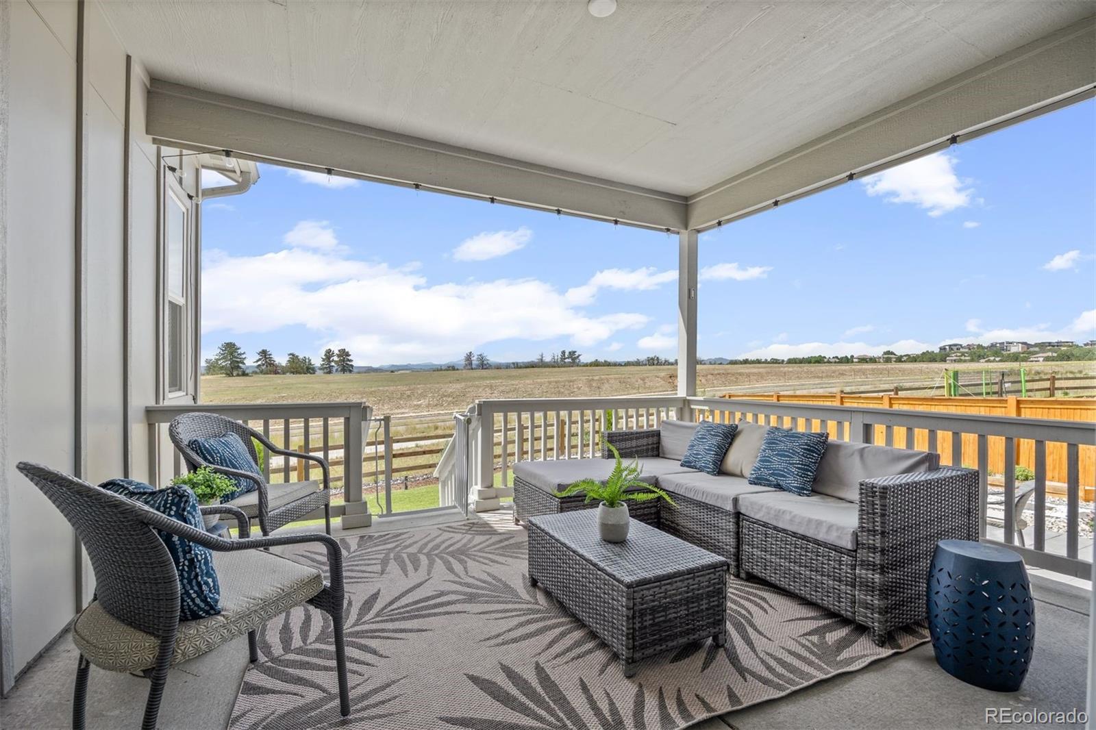 6346 Rockingham Way Castle Pines, CO 80108 - Photo 11 of 43 a balcony with furniture and view of lake