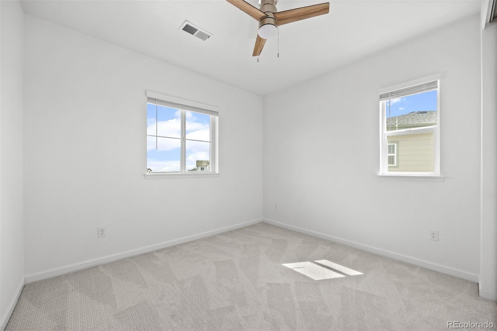 6346 Rockingham Way Castle Pines, CO 80108 - Photo 26 of 43 an empty room with windows
