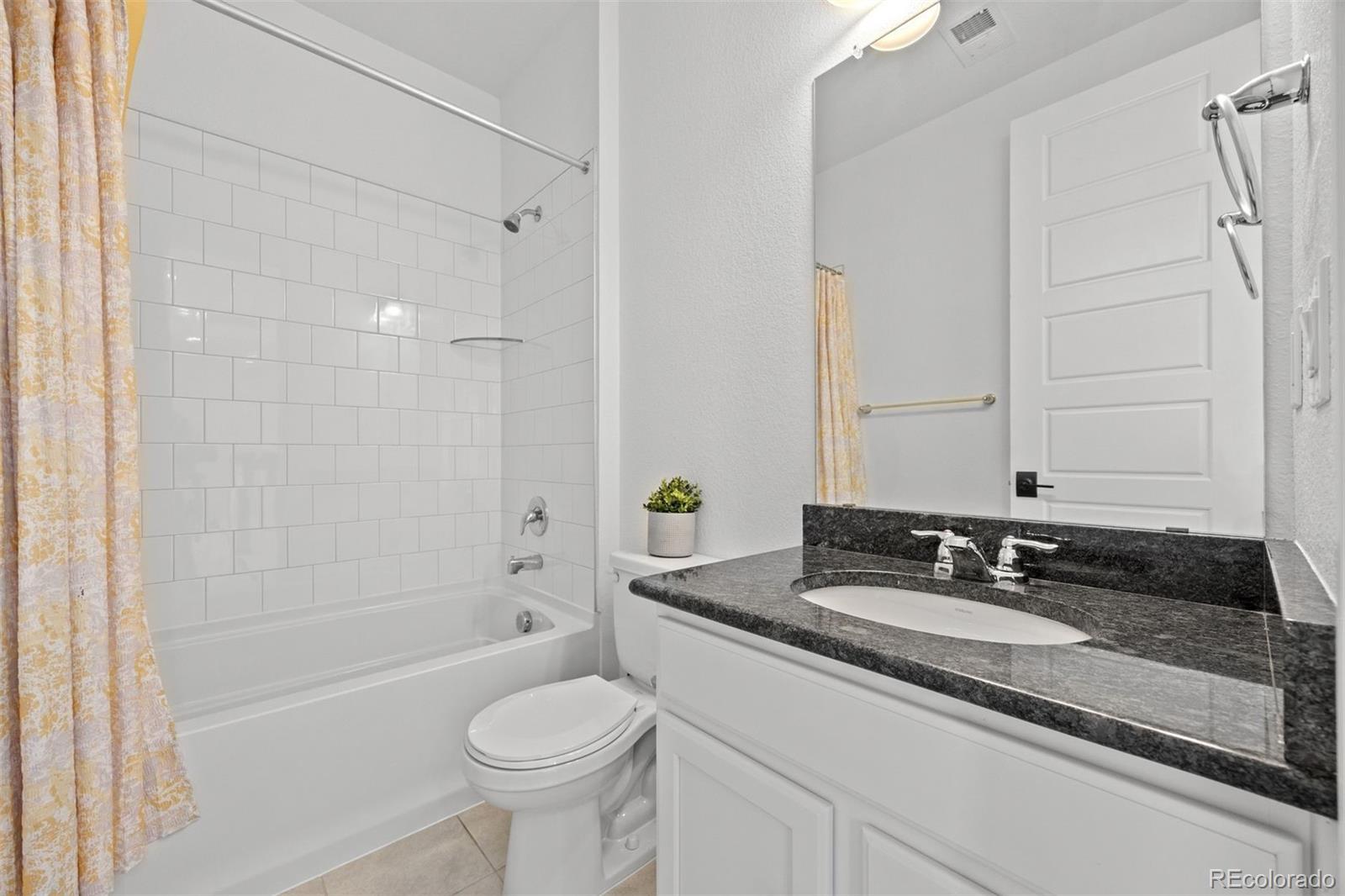 6346 Rockingham Way Castle Pines, CO 80108 - Photo 27 of 43 a bathroom with a granite countertop sink toilet and shower