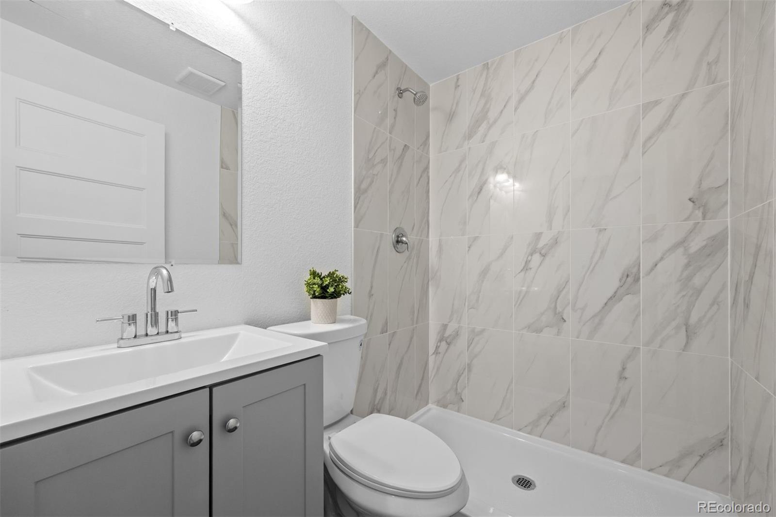 6346 Rockingham Way Castle Pines, CO 80108 - Photo 31 of 43 a bathroom with a sink a toilet and shower