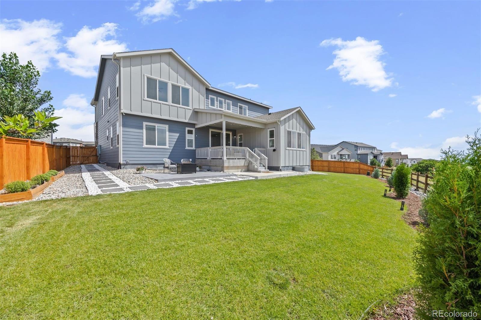 6346 Rockingham Way Castle Pines, CO 80108 - Photo 34 of 43 a front view of a house with garden and patio