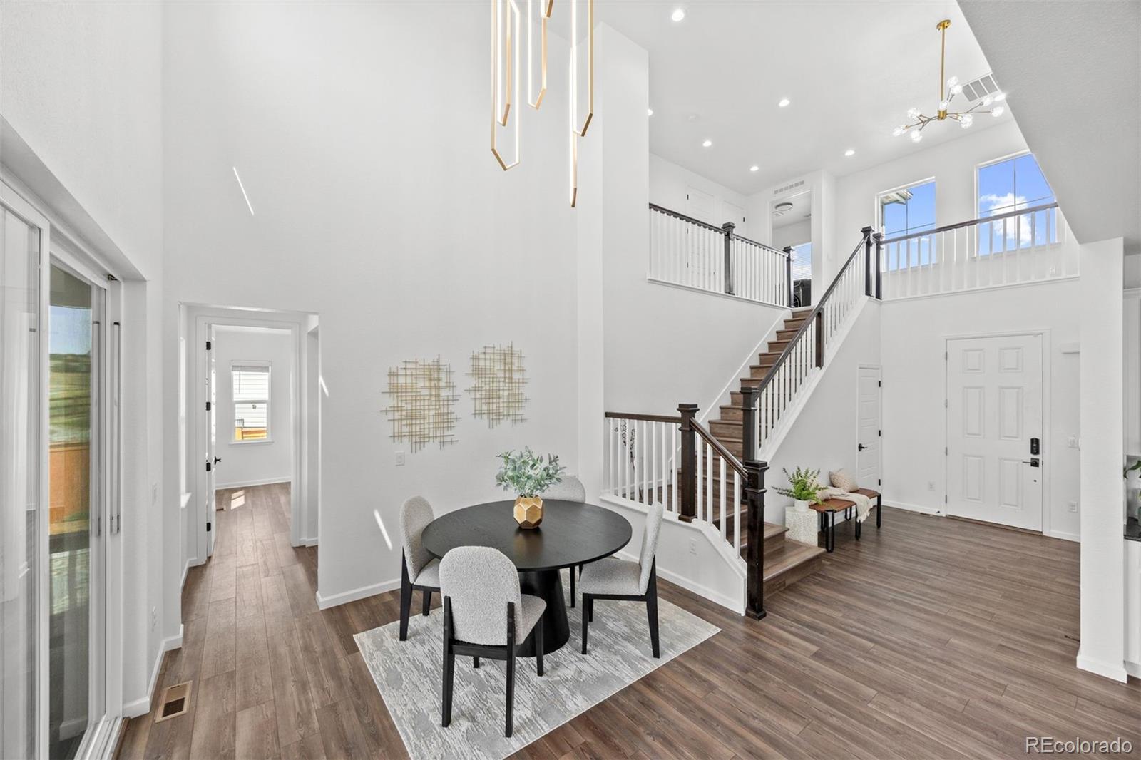 6346 Rockingham Way Castle Pines, CO 80108 - Photo 4 of 43 a view of a room with furniture and wooden floor