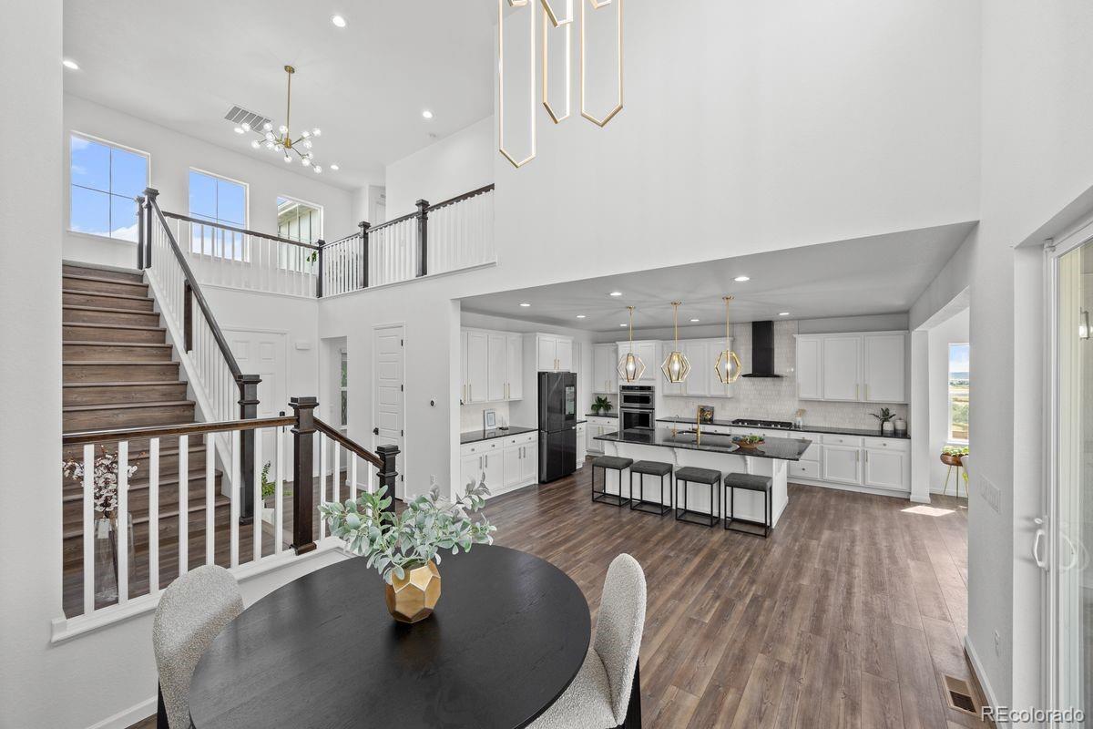 6346 Rockingham Way Castle Pines, CO 80108 - Photo 5 of 43 a dining room with furniture entryway and wooden floor