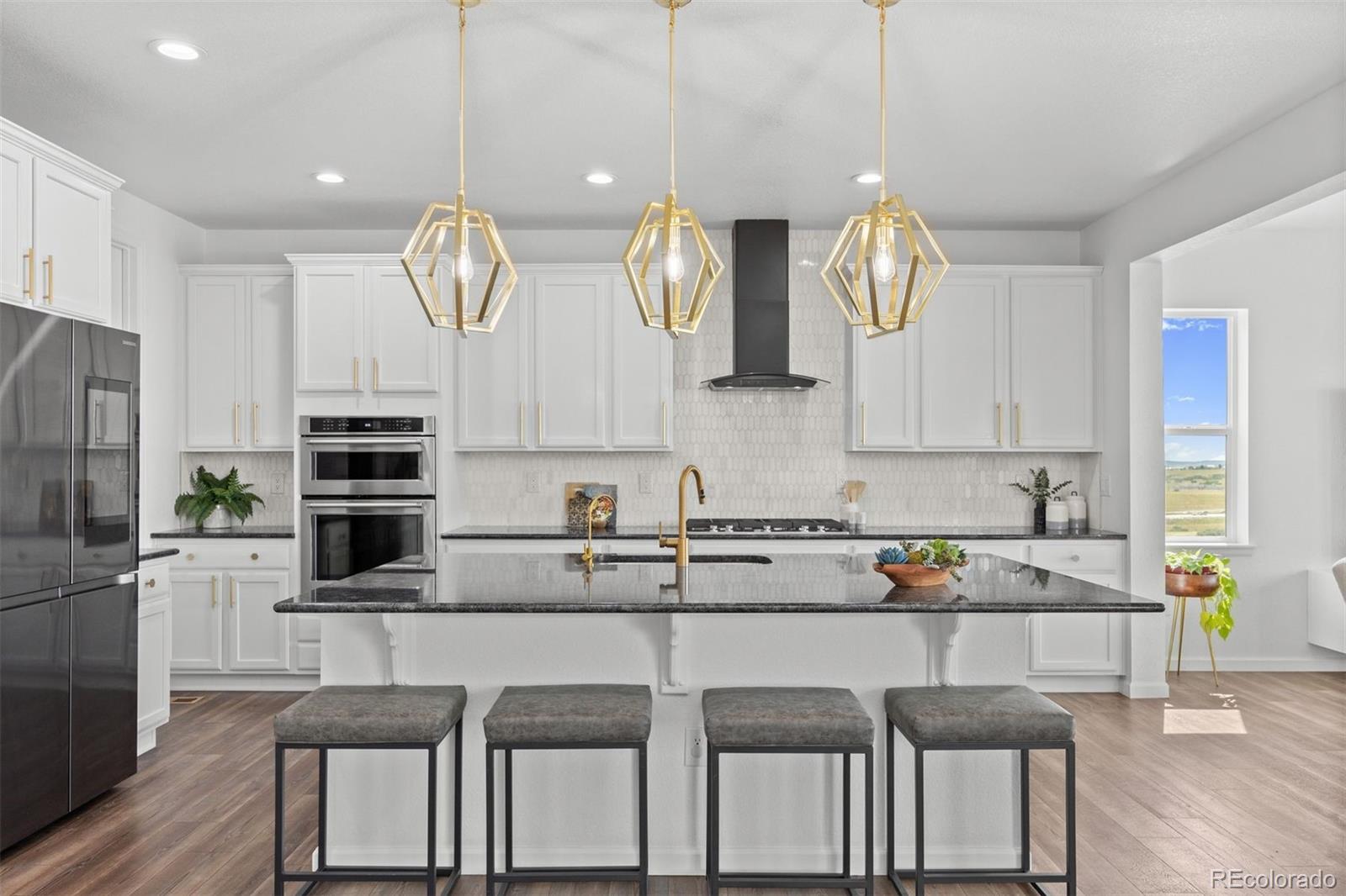 6346 Rockingham Way Castle Pines, CO 80108 - Photo 7 of 43 a kitchen with a sink cabinets and window