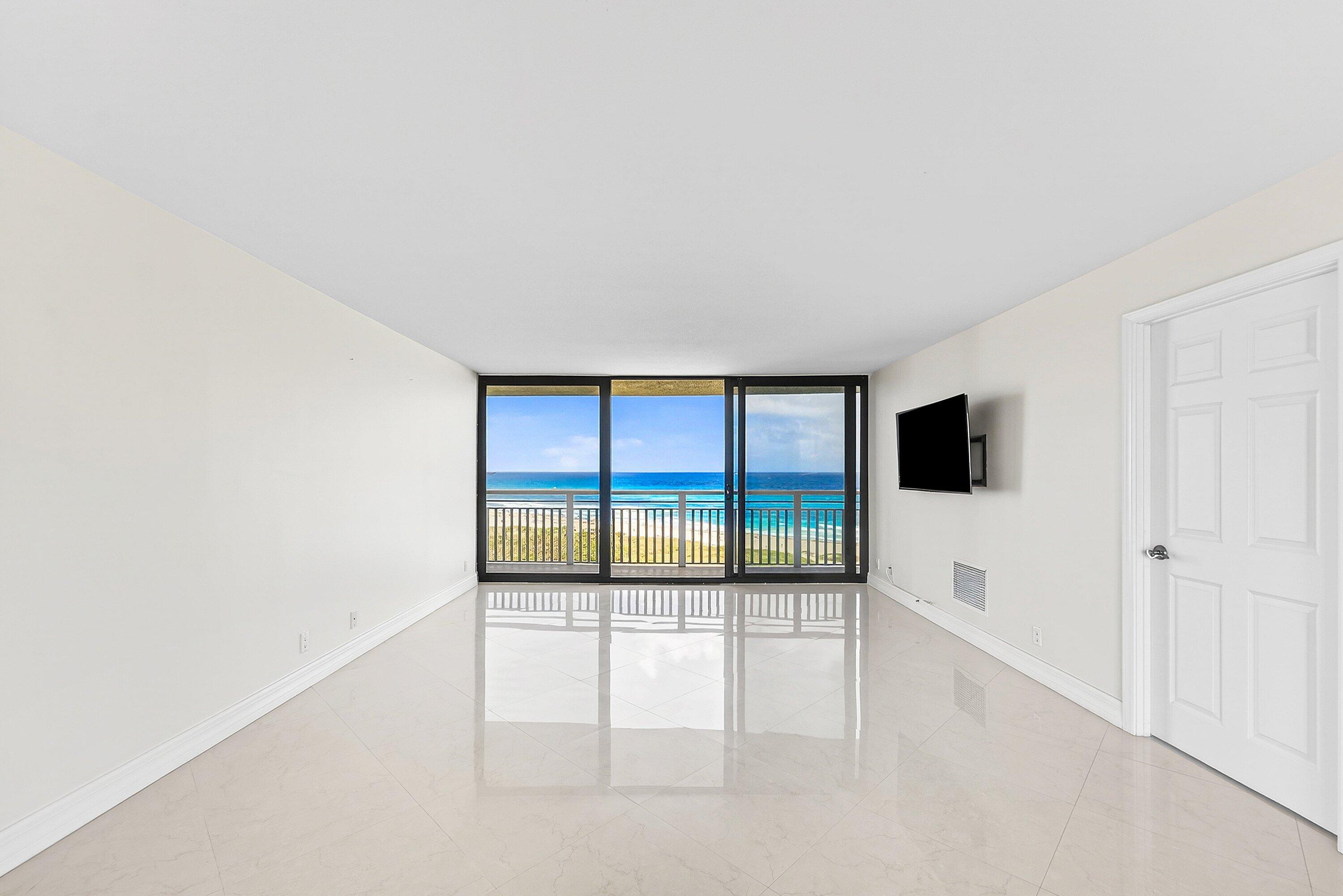 3000 North Ocean Drive, Unit 8F Singer Island, FL 33404 - Photo 21 of 66 an empty room with floor to ceiling window and an outdoor view