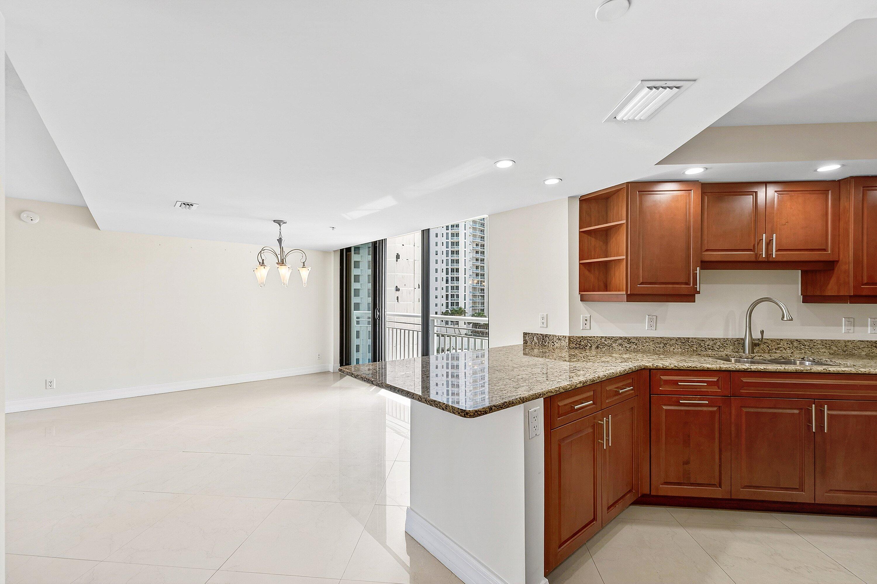 3000 North Ocean Drive, Unit 8F Singer Island, FL 33404 - Photo 25 of 66 a kitchen with a sink and cabinets