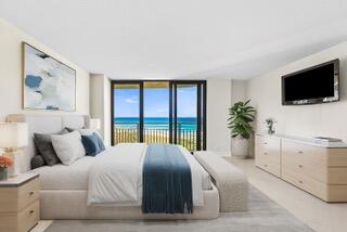 3000 North Ocean Drive, Unit 8F Singer Island, FL 33404 - Photo 5 of 66 a spacious bedroom with a large bed and a flat screen tv