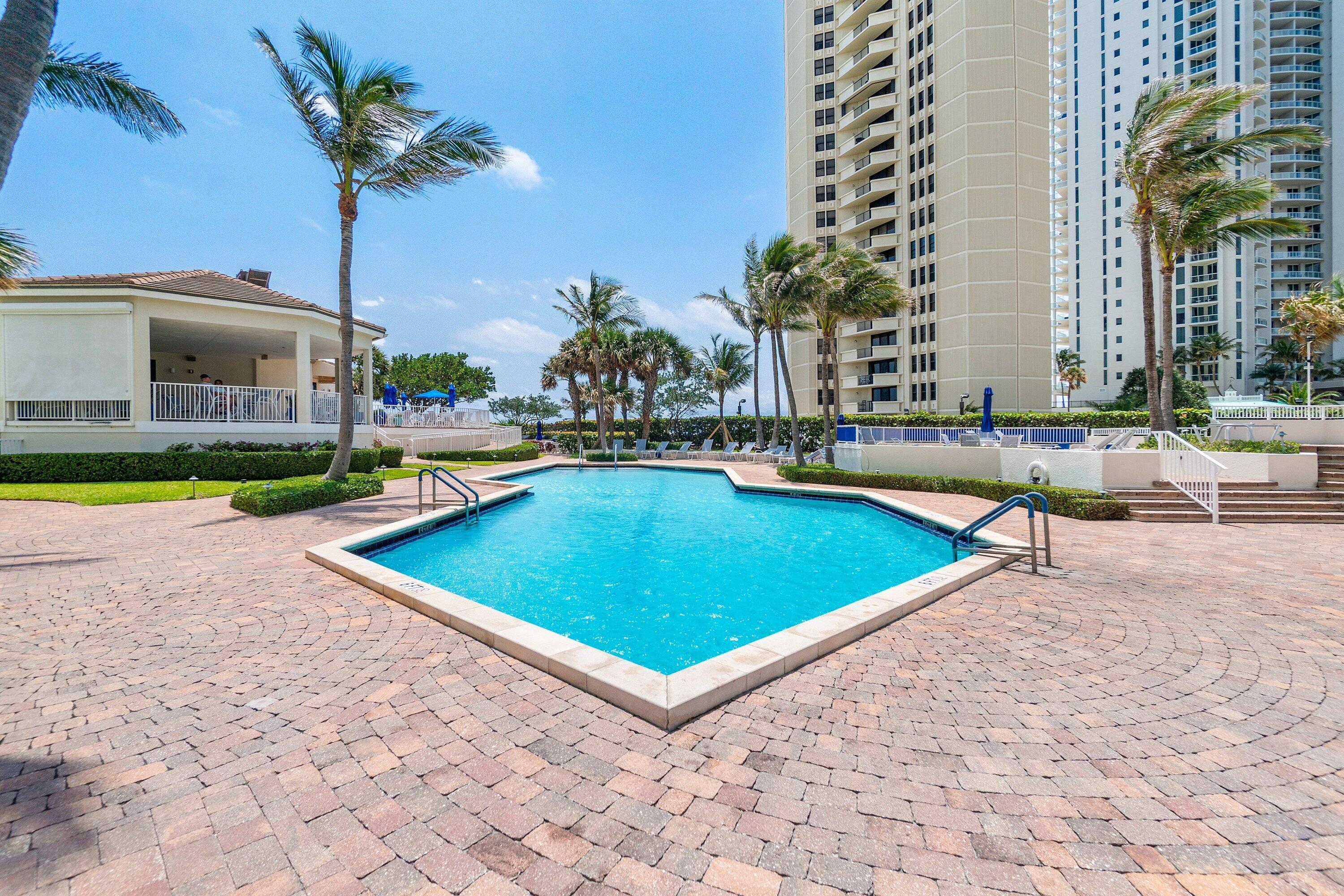 3000 North Ocean Drive, Unit 8F Singer Island, FL 33404 - Photo 63 of 66 a view of a swimming pool with a lounge chairs