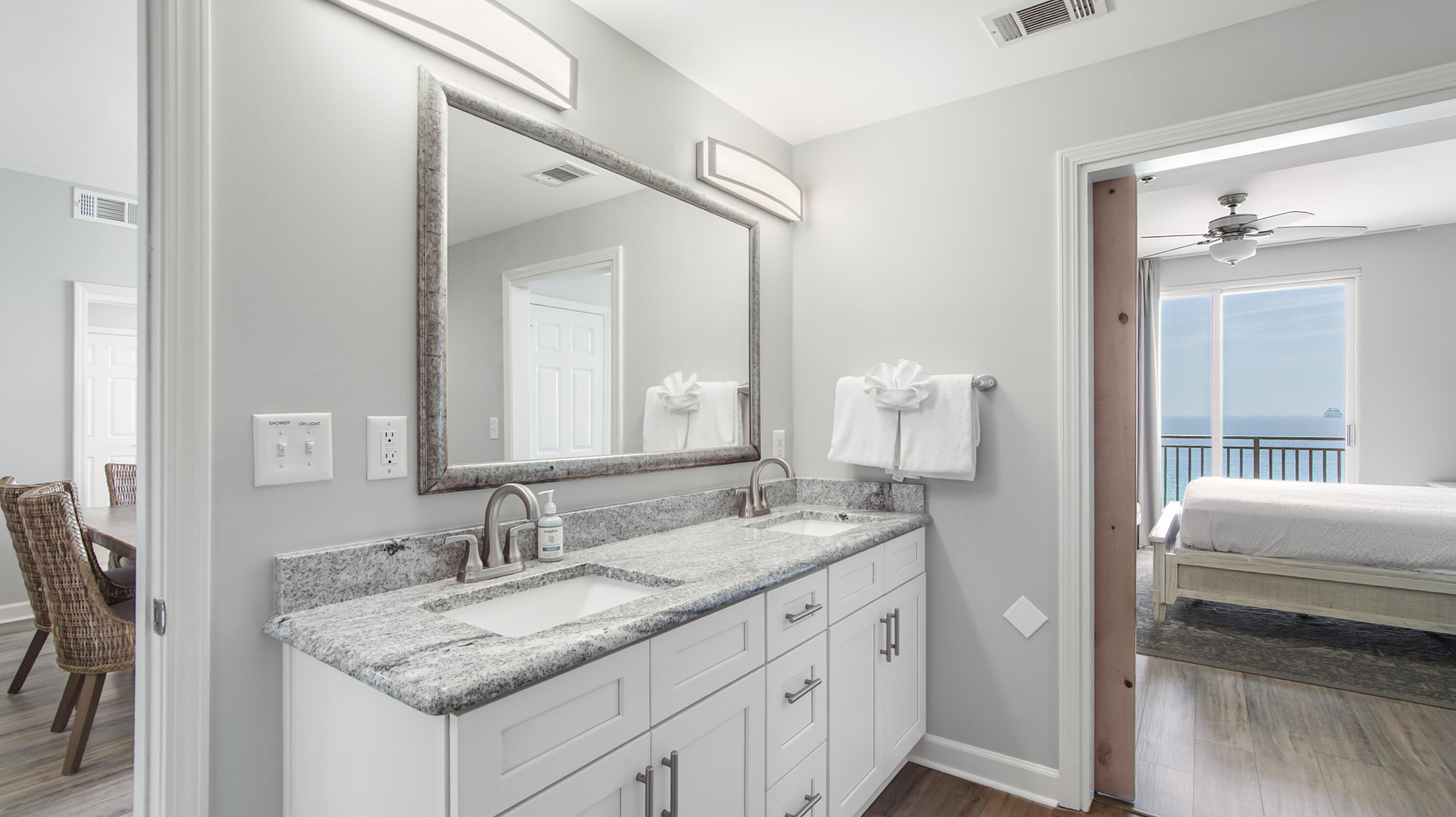 17739 Front Beach Road, Unit 507W Panama City Beach, FL 32413 - Photo 12 of 49 a en suite bathroom with a granite countertop sink and a mirror
