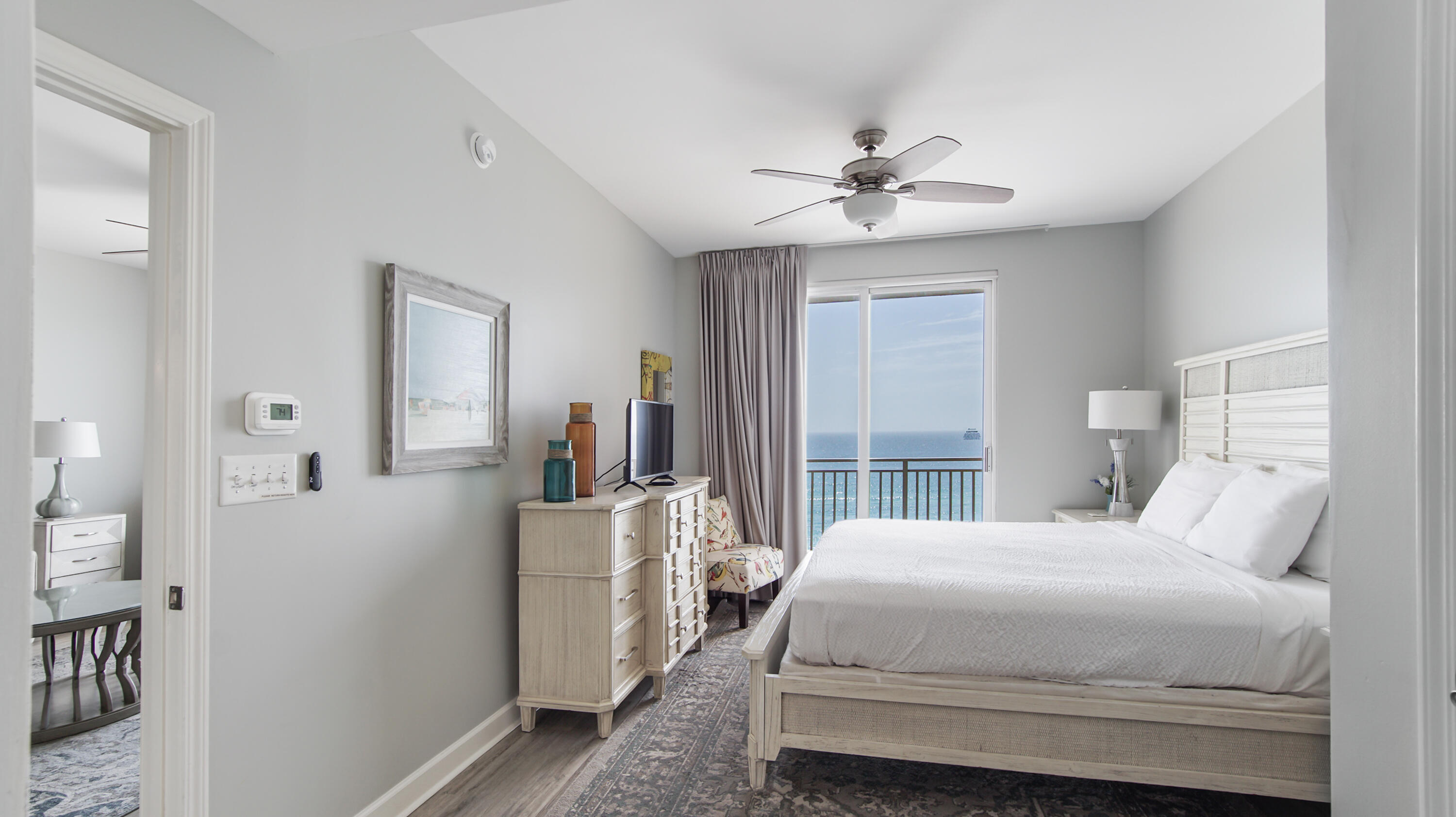 17739 Front Beach Road, Unit 507W Panama City Beach, FL 32413 - Photo 14 of 49 a bedroom with a bed and a chandelier